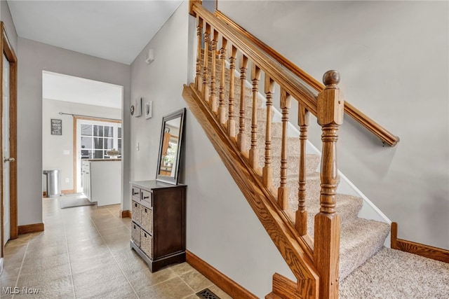 staircase featuring baseboards