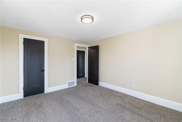 unfurnished bedroom featuring visible vents, baseboards, and carpet floors