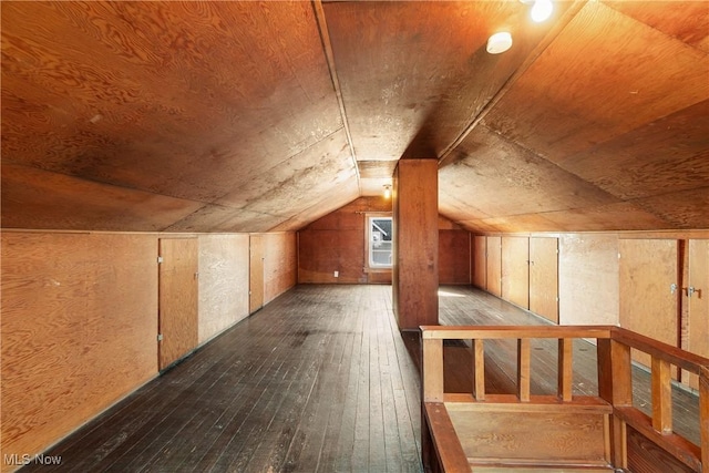 bonus room with lofted ceiling and hardwood / wood-style flooring