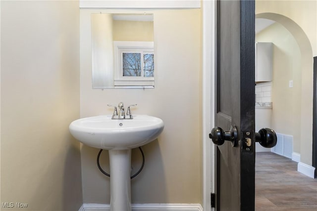 bathroom featuring visible vents, baseboards, and wood finished floors