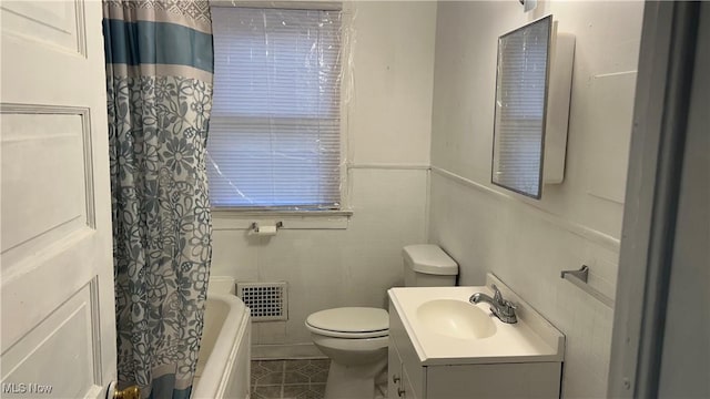 full bathroom with tile patterned floors, visible vents, toilet, tile walls, and vanity