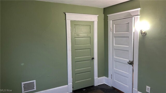 interior space featuring baseboards and visible vents