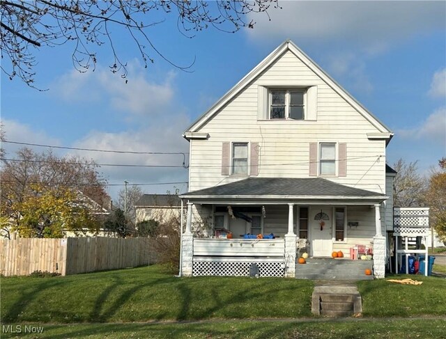 view of front of home featuring a porch, a front yard, and fence