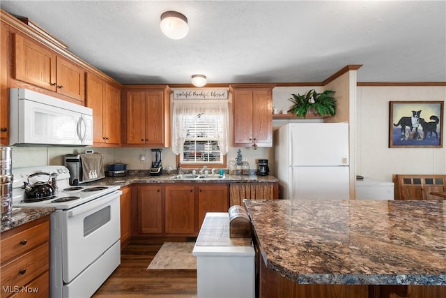 kitchen with white appliances, brown cabinetry, dark wood-type flooring, and ornamental molding