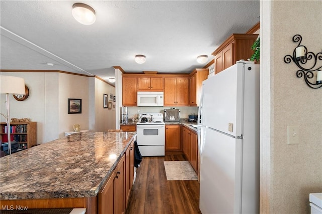 kitchen with white appliances, brown cabinets, and dark wood finished floors