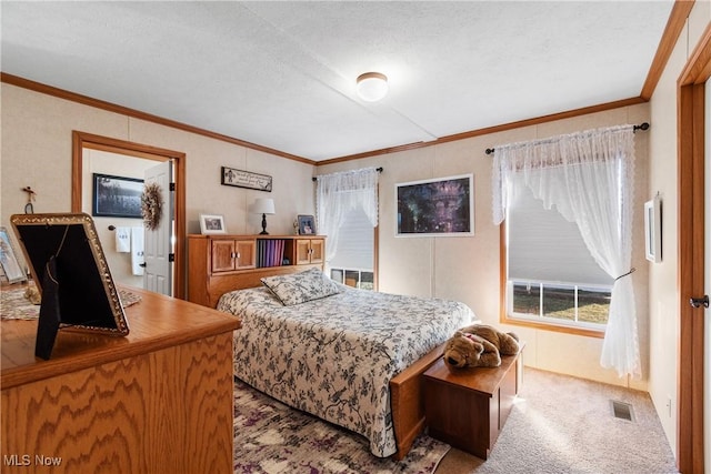 bedroom with visible vents, carpet, and crown molding