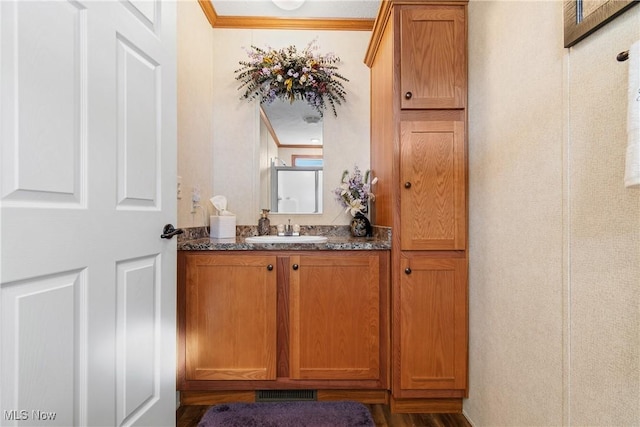 bar with crown molding and a sink