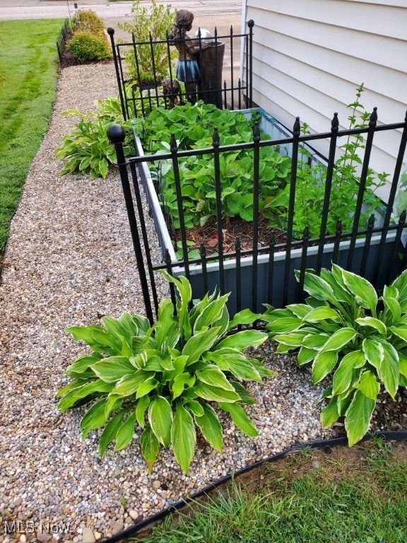 exterior space with a vegetable garden and fence