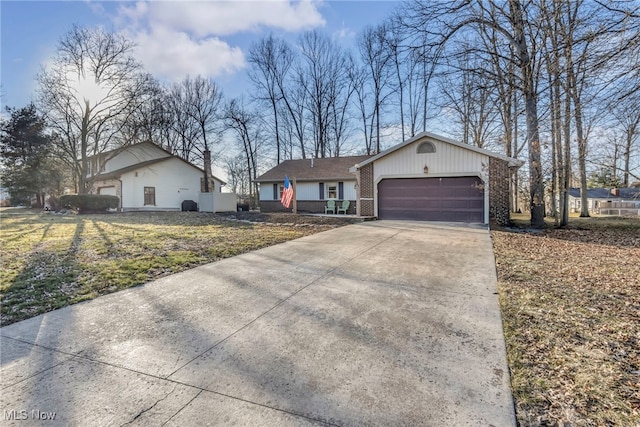 single story home featuring a garage, brick siding, concrete driveway, and a front yard