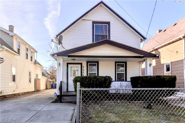 view of front of house with covered porch and a fenced front yard