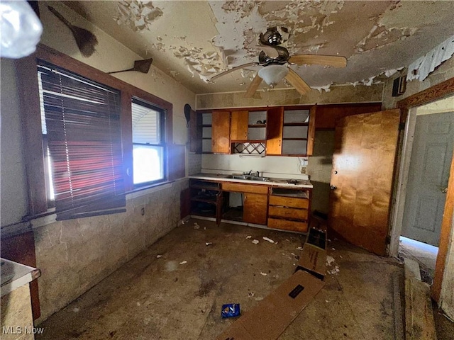 kitchen with light countertops, brown cabinetry, and ceiling fan