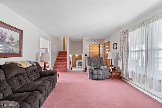 carpeted living room with stairs and a baseboard heating unit