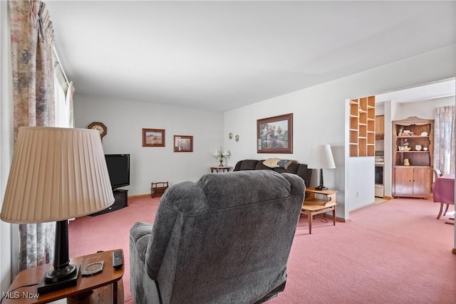 carpeted living room with baseboards