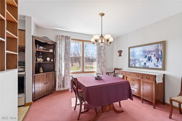 dining area featuring light carpet, a chandelier, and baseboards