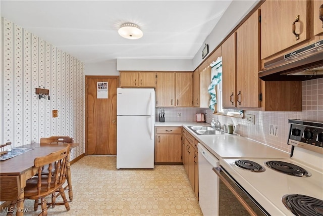 kitchen with white appliances, light floors, a sink, light countertops, and backsplash