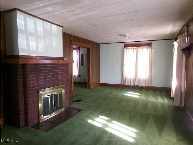 unfurnished living room with visible vents, a brick fireplace, baseboards, and carpet floors