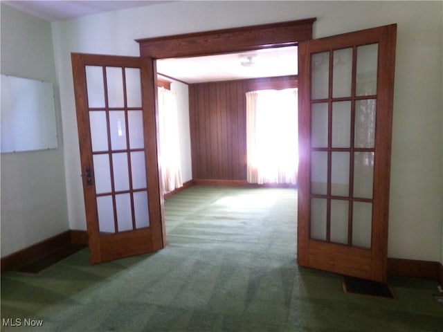 spare room featuring baseboards and carpet