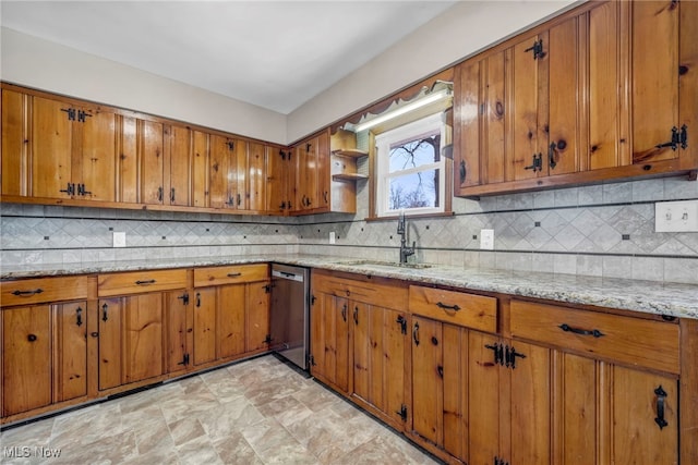 kitchen featuring dishwasher, brown cabinets, and a sink