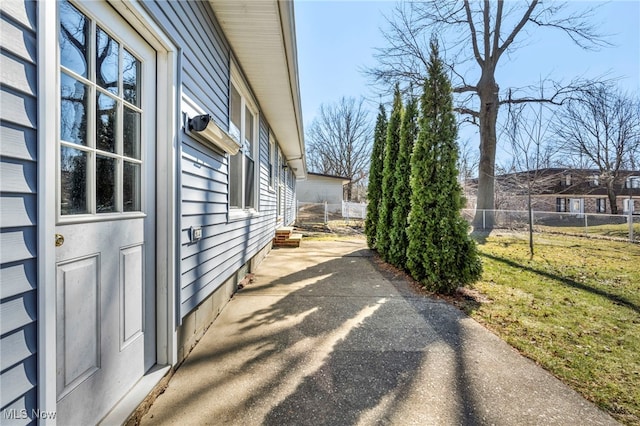 view of side of property featuring a yard and fence