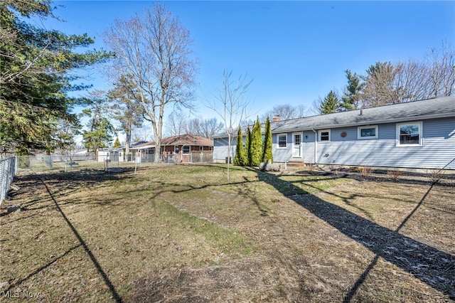 view of yard with entry steps and fence