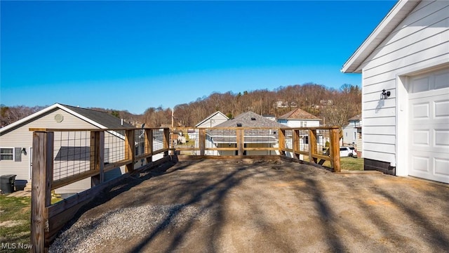 view of yard featuring a garage and a wooden deck