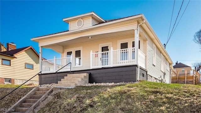 bungalow-style house with covered porch and stairs