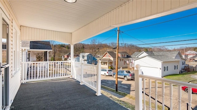 view of patio / terrace with a residential view and covered porch