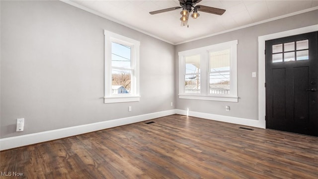 foyer featuring visible vents, baseboards, dark wood-type flooring, and crown molding