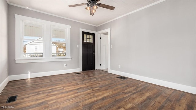 entrance foyer featuring wood finished floors, baseboards, visible vents, and ornamental molding