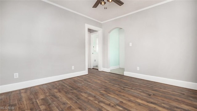 unfurnished room with crown molding, ceiling fan, baseboards, wood finished floors, and arched walkways