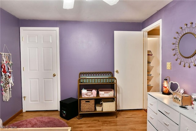 bedroom with baseboards and light wood-style floors