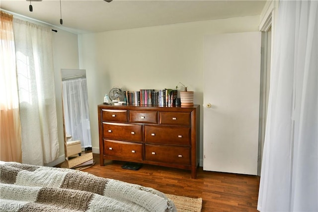 bedroom with dark wood-style floors