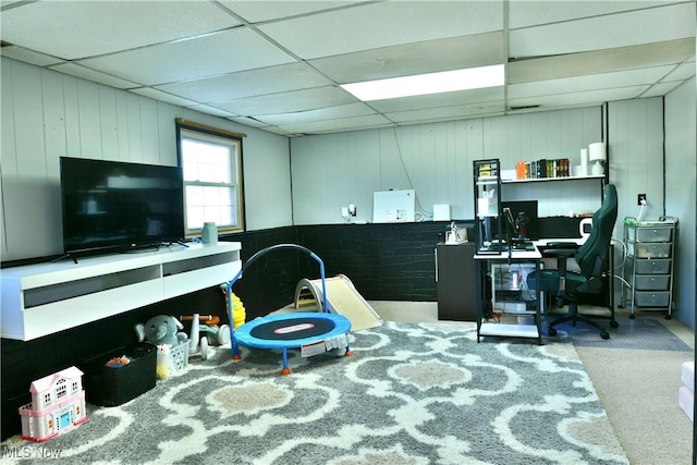 office space with a paneled ceiling