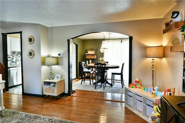 interior space featuring hardwood / wood-style floors, arched walkways, and a sink