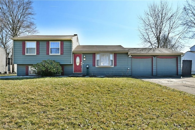 split level home featuring a front lawn, an attached garage, and driveway