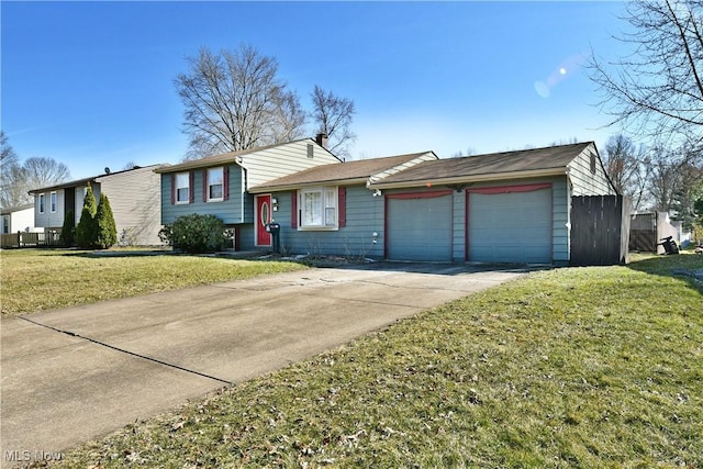 tri-level home with a front yard, a garage, and driveway