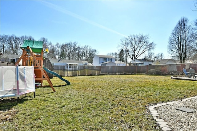 view of yard with a fenced backyard and a playground