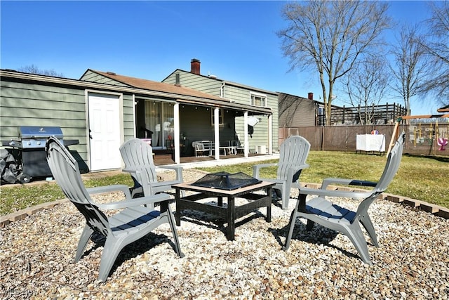 exterior space with area for grilling, fence, and an outdoor fire pit