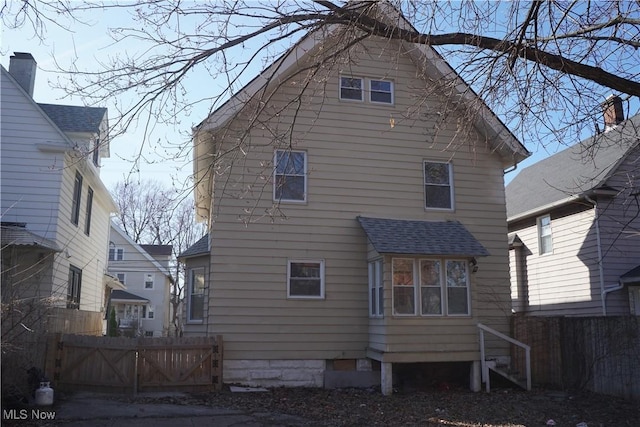 1341 Beach Ave, Lakewood, OH 44107 - rear view of property with roof with shingles and fence