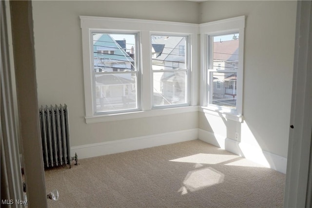 1341 Beach Ave, Lakewood, OH 44107 - unfurnished room featuring carpet flooring, radiator, and baseboards