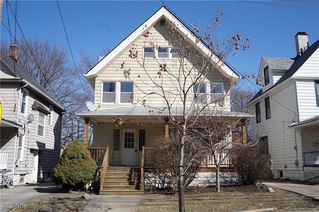 american foursquare style home featuring covered porch