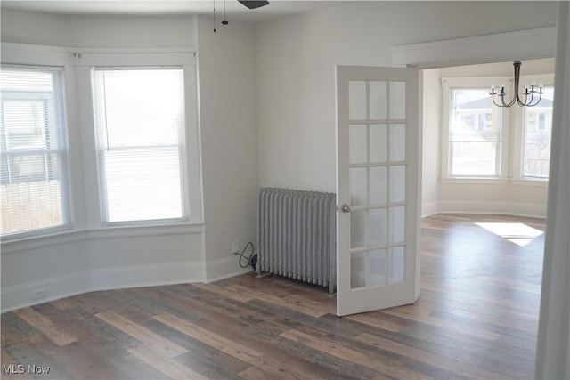 1341 Beach Ave, Lakewood, OH 44107 - unfurnished room featuring baseboards, wood finished floors, and radiator heating unit