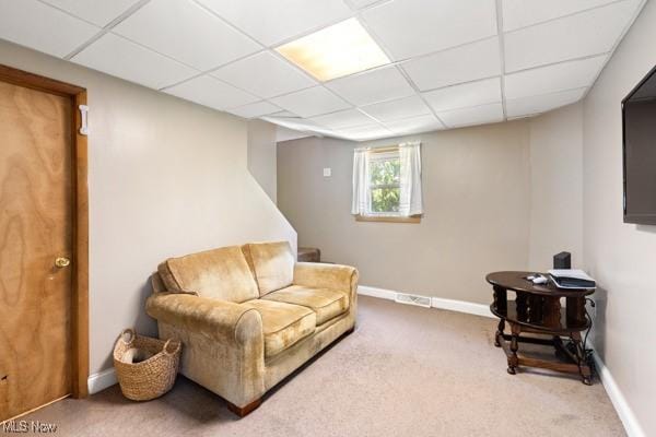 sitting room with baseboards, carpet, and a paneled ceiling