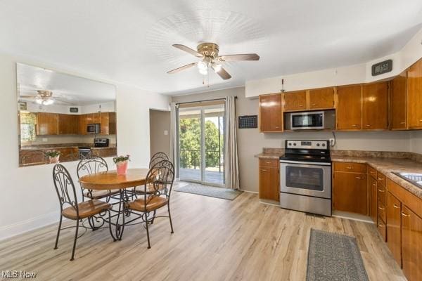 kitchen with brown cabinets, stainless steel appliances, and ceiling fan