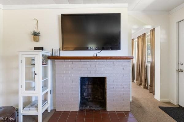 interior details with ornamental molding, a fireplace with flush hearth, and carpet
