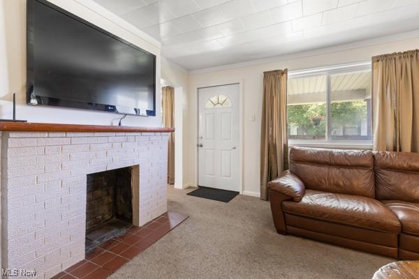 living room with carpet and a brick fireplace