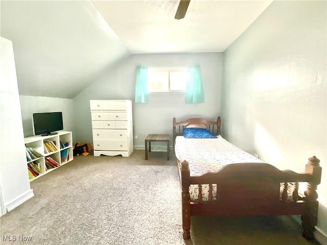 bedroom with a ceiling fan, carpet, and lofted ceiling