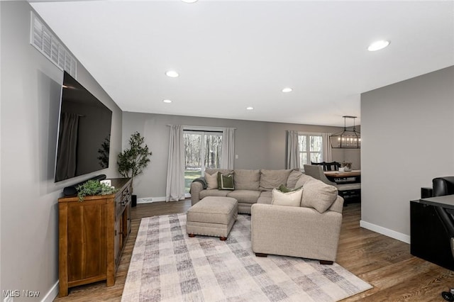 living area with recessed lighting, baseboards, and wood finished floors