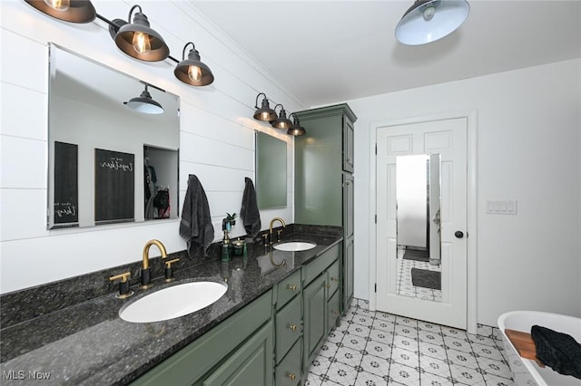 full bathroom featuring a sink, ornamental molding, and double vanity