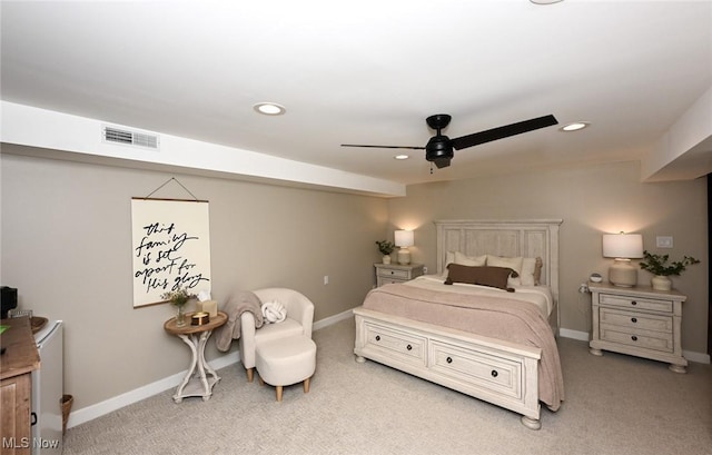 bedroom with visible vents, light colored carpet, and baseboards